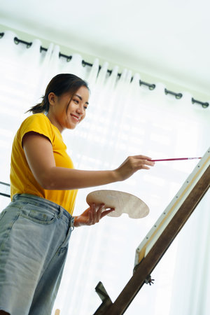 Portrait of an Asian woman designing art in her spare timeの写真素材