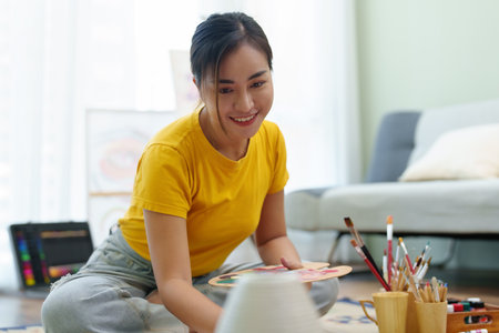 Portrait of an Asian woman designing art in her spare timeの写真素材