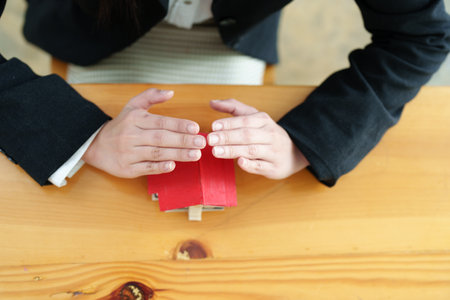 portrait of an asian woman, Agent, buy and sell land, property tax, show the concept of protecting the house to insure the risk of damage to the home.の写真素材