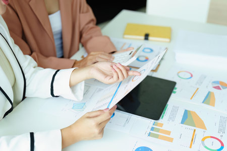 Portrait of a young Asian businesswoman discussing how to analyze profitability and marketing against digital competitors.の写真素材