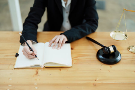 Portrait of a beautiful Asian lawyer studying a lawsuit for a client before going to court.の写真素材