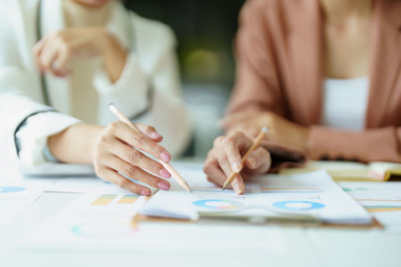 A portrait of a marketing employee and a salesperson using product documentation to plan sales.の写真素材