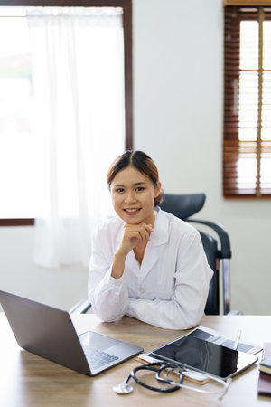 Portrait of an Asian doctor using a computer.の写真素材
