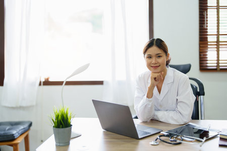 Portrait of an Asian doctor using a computer.の写真素材