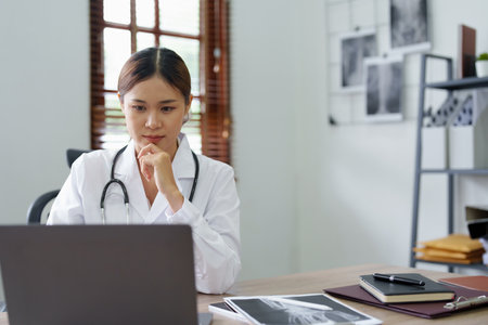 Portrait of an Asian doctor using a computer.の写真素材