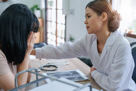 Portrait of an Asian female doctor encouraging patients from early stage cancer, concept of stress, depression, anxiety.の写真素材