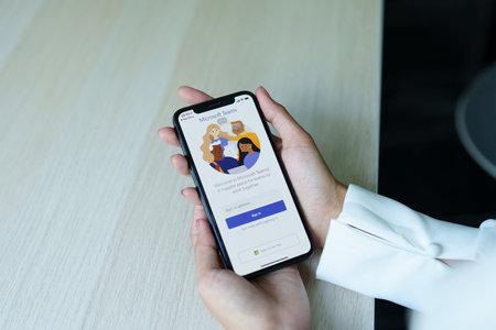CHIANG MAI, THAILAND - Sep 08, 2022 : A working from home employee is downloading the Microsoft Teams social platform, ready for remote working in isolation from homeのeditorial素材