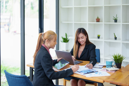 Portrait of a young Asian businesswoman consulting, planning marketing to improve product quality for customers.の写真素材
