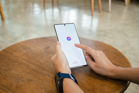 Chiang Mai Thailand. July 09, 2022. Woman holds smart phone with facebook application on the screen. facebook is a photo-sharing app for smartphones.のeditorial素材
