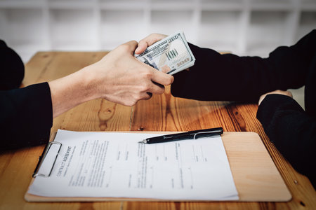 Corrupt concept, corrupt private entrepreneurs are handing over money to government employees to offer to sign contracts that benefit their company.の写真素材