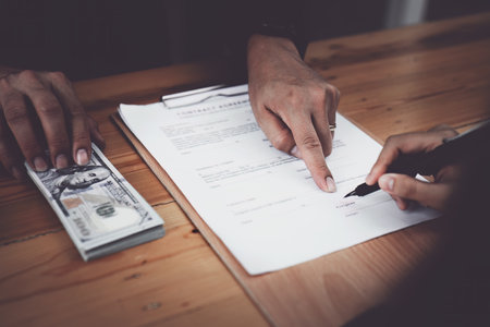 Corruption concept, law, civil servants sign government project documents and receive corruption money from private companies.の写真素材