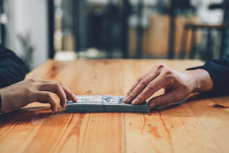 Corrupt concept, corrupt private entrepreneurs are handing over money to government employees to offer to sign contracts that benefit their company.の写真素材