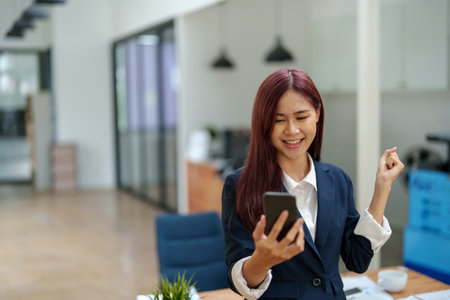 Businessmen use the smart phone to contact partners, success concept.の写真素材