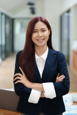 Portrait of a business woman standing with her arms crossed.の写真素材