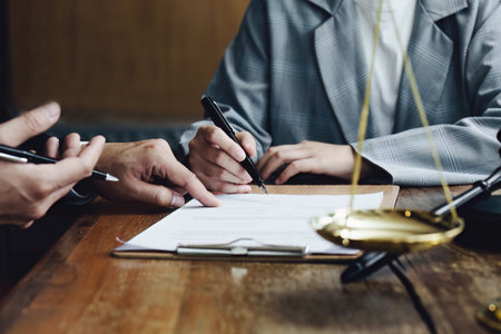 Discussing legal matters and signing important documents.の写真素材