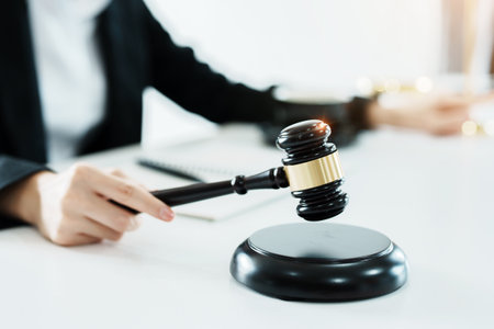 Portrait of a beautiful Asian lawyer studying a lawsuit for a client before going to court.の写真素材