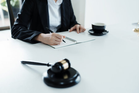 Portrait of a beautiful Asian lawyer studying a lawsuit for a client before going to court.の写真素材