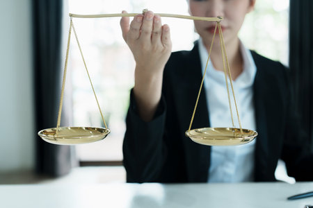Portrait of a beautiful Asian lawyer studying a lawsuit for a client before going to court.の写真素材