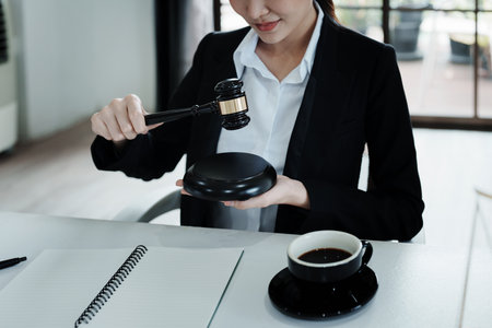 Portrait of a beautiful Asian lawyer studying a lawsuit for a client before going to court.の写真素材