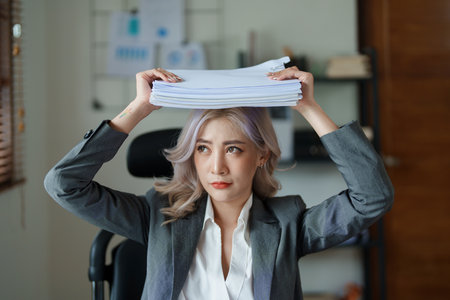 Portrait of sme business owner, woman using computer and financial statements Anxious expression on expanding the market to increase the ability to invest in business.の写真素材