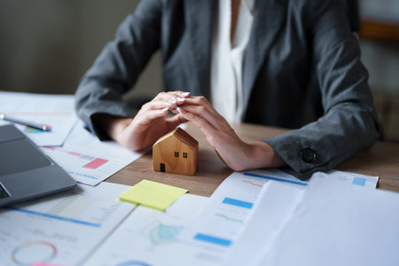portrait of an asian man, Agent, buy and sell land, property tax, show the concept of protecting the house to insure the risk of damage to the home.の写真素材