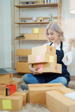 Starting small business entrepreneur of independent Asian woman smiling using computer laptop with...
