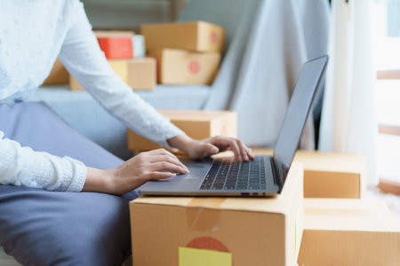 Starting small business entrepreneur of independent Asian woman smiling using computer laptop with...