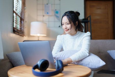 Portrait of a beautiful Asian teenage girl using a computer.の写真素材