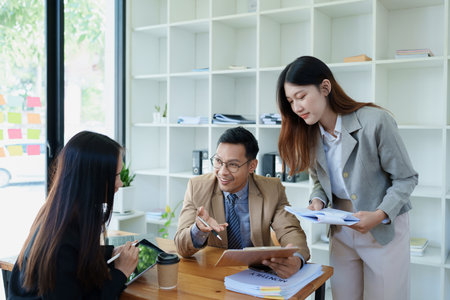 Asian entrepreneurs and business people meeting in a conference room in business planning, financial budget and investment risk assessment to analyze customer groups to increase company growth.の写真素材
