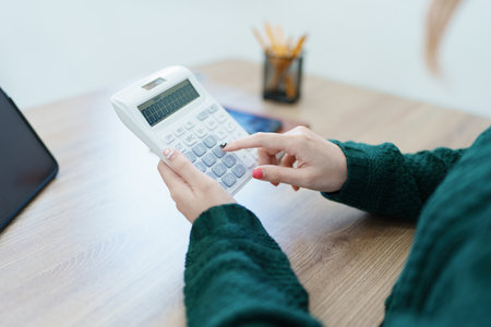 business owner or Asian female marketers are using calculator to calculate and tablet computer in office work.の写真素材