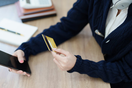 Online Shopping and Internet Payments, Asian man are using their credit card and mobile phone to shop online or conduct errands in the digital worldの写真素材