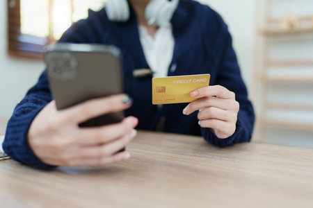 Online Shopping and Internet Payments, Asian man are using their credit card and mobile phone to...
