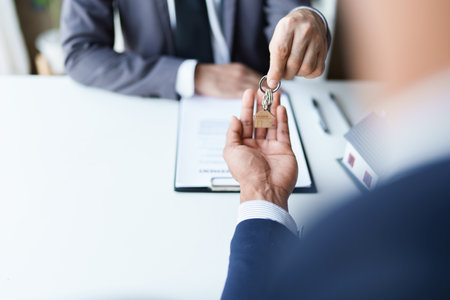 Real estate company to buy houses and land are delivering keys and houses to customers after agreeing to make a home purchase agreement and make a loan agreementの写真素材