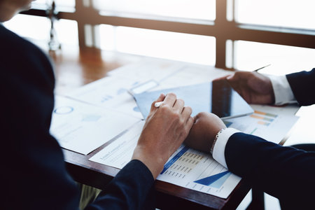 business group people are meeting and discussing budget and marketing plans in order to strategize to win over partners in order to keep the company number one.の写真素材