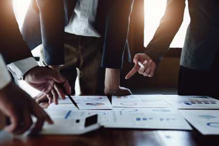 business group people are meeting and discussing budget and marketing plans in order to strategize...