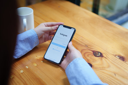CHIANG MAI, THAILAND - Jun 30, 2022 : woman hand holding smartphone mobile with login screen of instagram application. Instagram is largest and most popular photograph social networking.のeditorial素材