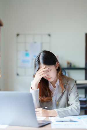 Portrait of sme business owner, man using computer and financial statements Anxious expression on expanding the market to increase the ability to invest in business.の写真素材