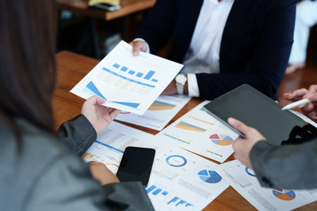 Business group people meeting and discuss to come up with conclusions on market, investment and marketing planning based on the financial budget provided by the company.の写真素材