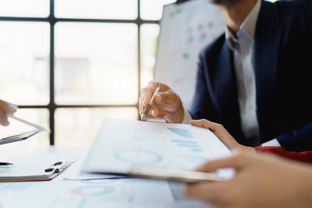 Team business adviser meeting to analyze and discuss the situation on the financial report n the meeting room with using documents, calculator, computer laptop in workの写真素材