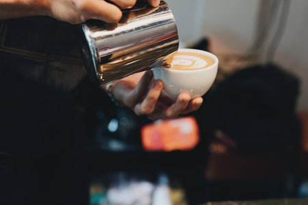 Asian male barista making coffee for customers.の写真素材
