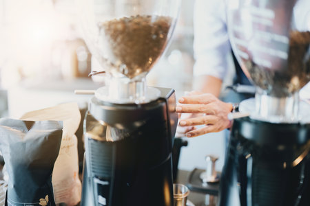 Asian male barista making coffee for customers.の写真素材