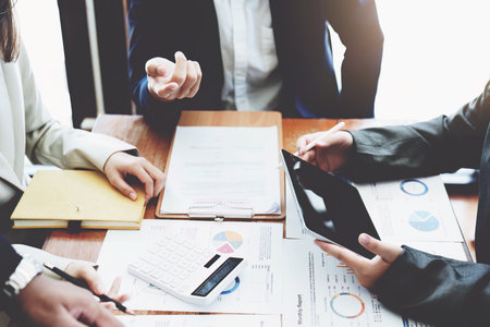 The companys businessmen meet and discuss to plan a marketing strategy and come to a conclusion on how to use the financial budget to avoid investment risks.の写真素材