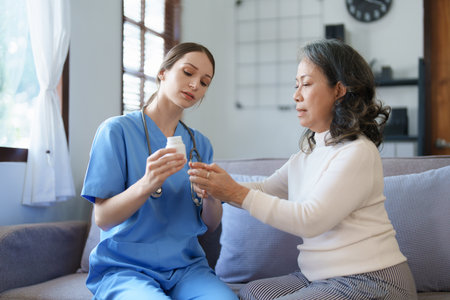Portrait of a female doctor giving medicine to an elderly patientの写真素材