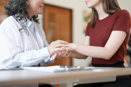 Portrait of a female doctor holding a patients hand to encourage the fight against diseaseの写真素材