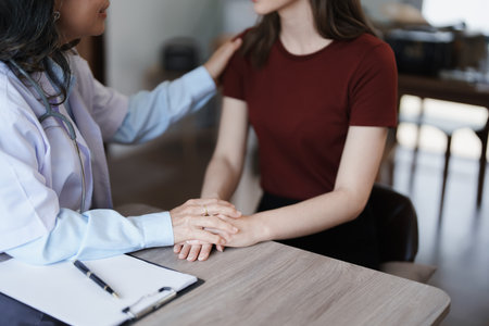 Portrait of a female doctor holding a patients hand to encourage the fight against diseaseの写真素材