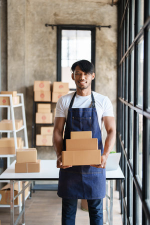 Young male entrepreneur successful with her SME businessの写真素材