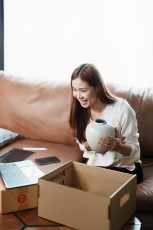 Starting small business entrepreneur of independent young Asian woman online seller using a computer...