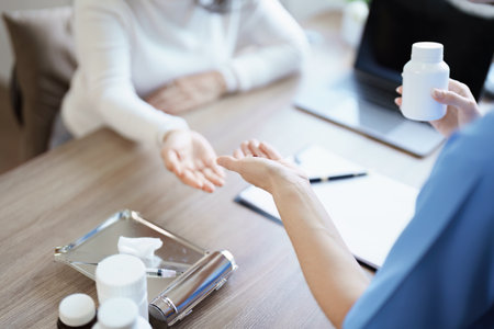 Portrait of a female doctor giving medicine to an elderly patientの写真素材