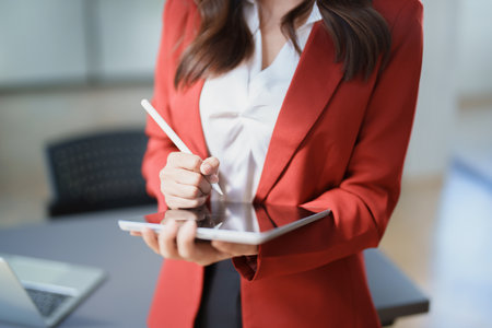 business owner or Asian female marketers are using tablet computer in office work.の写真素材