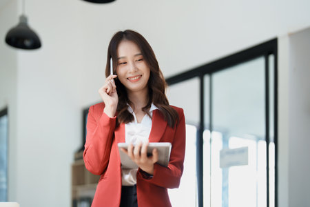 business owner or Asian female marketers are using tablet computer in office work.の写真素材